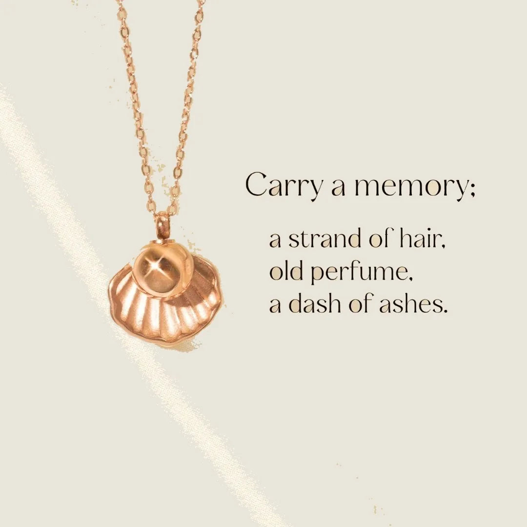 Rose gold memorial necklace pendant shaped like a shell, designed to hold ashes, with a delicate chain.