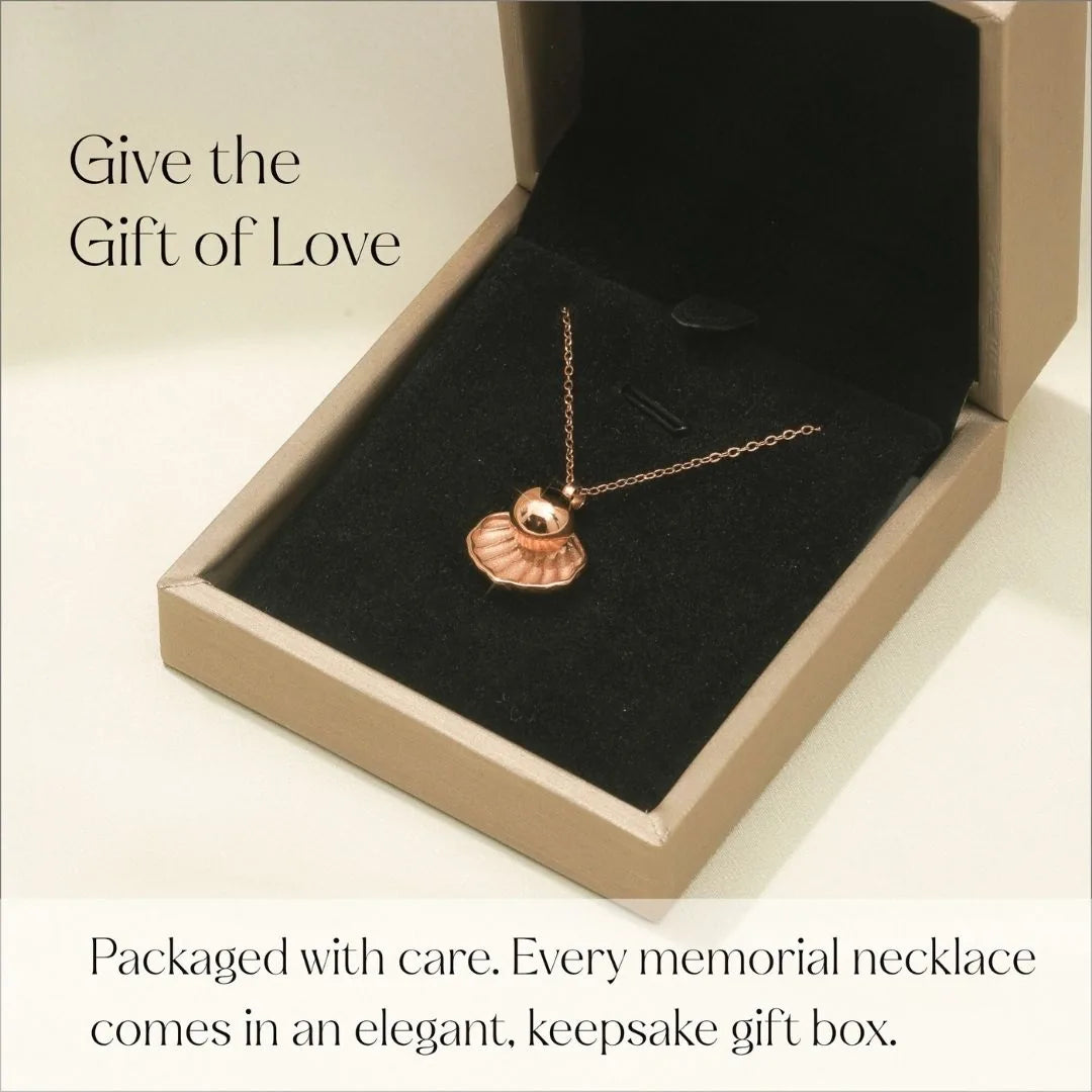 Rose gold memorial necklace in a black velvet-lined keepsake box, showcasing a delicate pendant design.