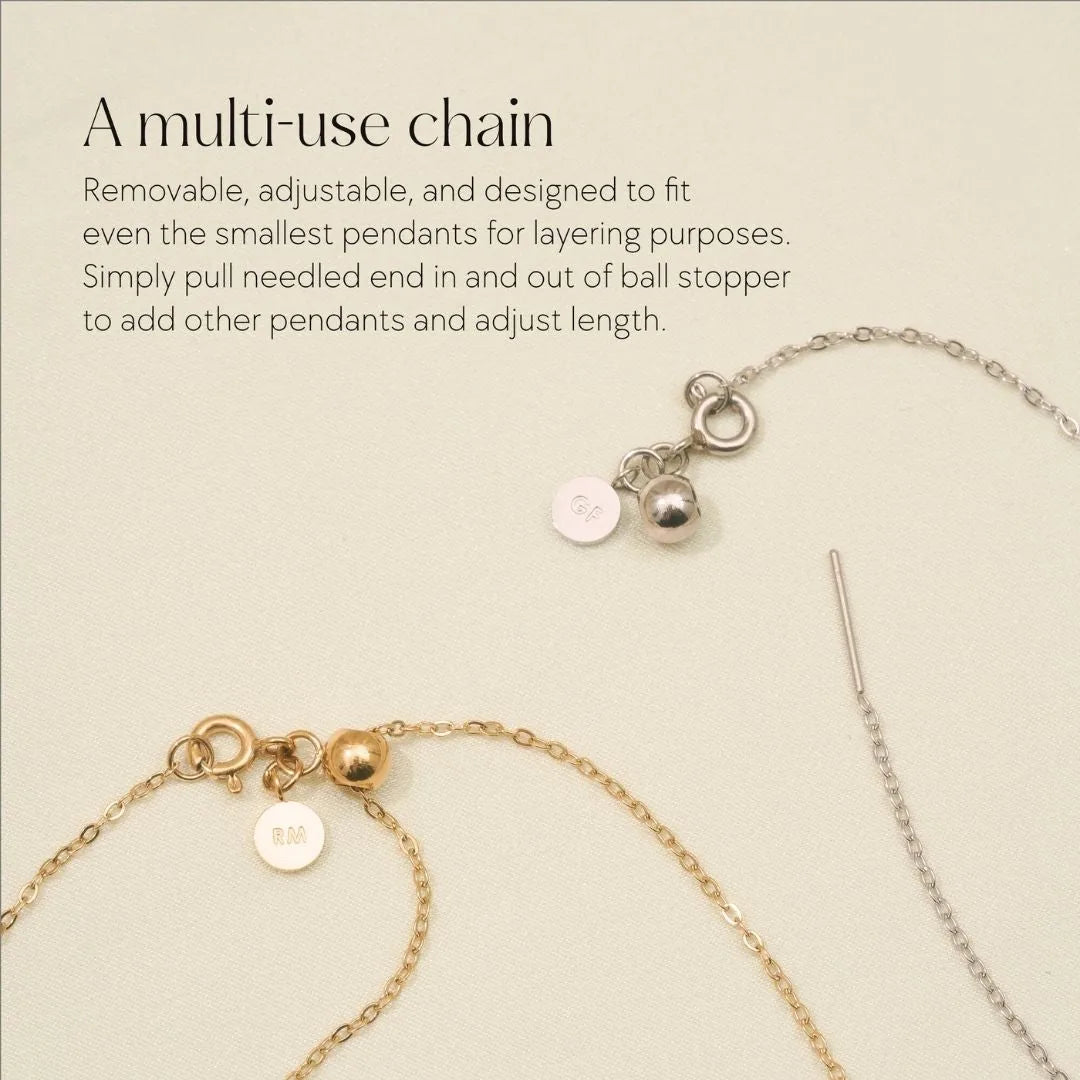 Adjustable gold and silver chains designed for layering, showcasing unique ball stoppers and engraved tags.