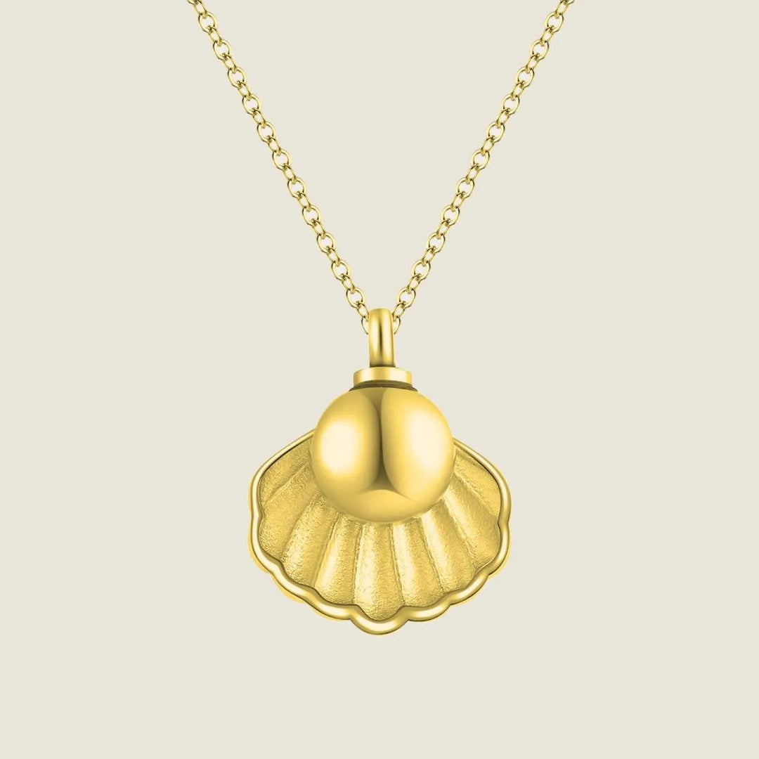 Gold Treasure Memorial Necklace shaped like a shell, designed to hold human ashes, with a delicate chain.