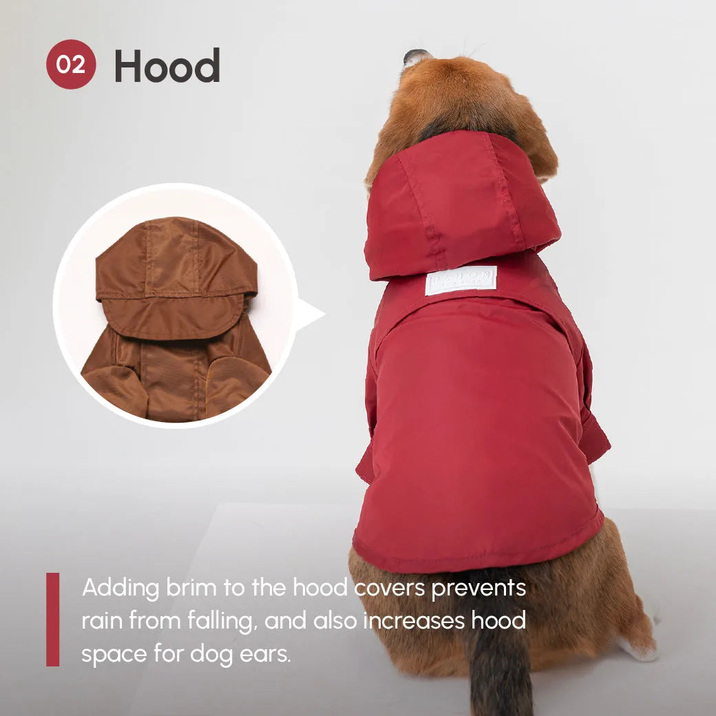 Burgundy dog raincoat with adjustable hood, featuring velcro closures and a back vent for leash access.