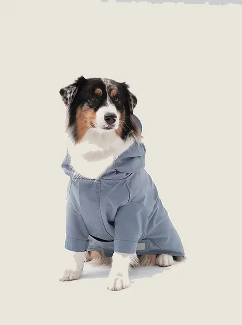 Light blue adjustable velcro raincoat for dogs, featuring a hood and comfortable fit, ideal for rainy days.