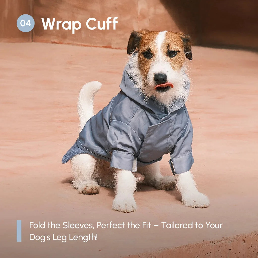 Light blue adjustable velcro raincoat on a small dog, featuring a hood and wrap cuffs for tailored fit.