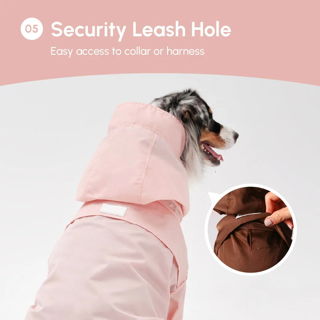 Light pink adjustable raincoat for dogs featuring a hood and leash hole, designed for easy wear and comfort.