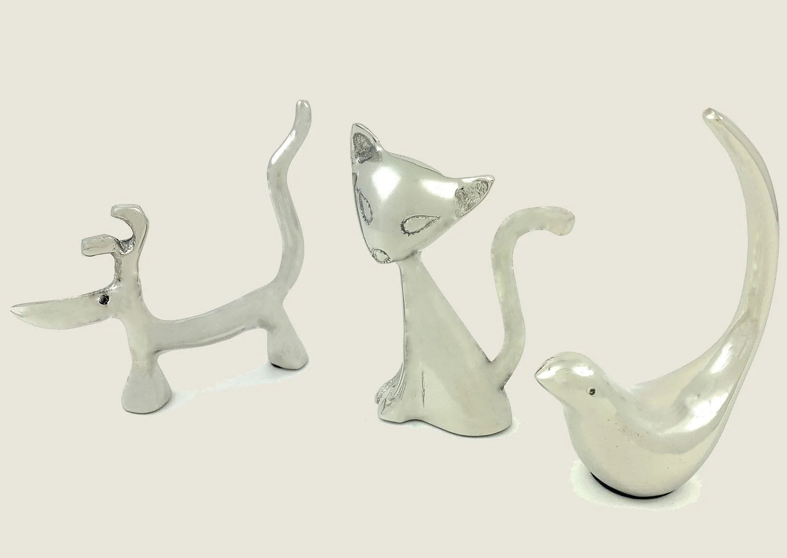 Silver dog, cat, and bird ring holders, each 4 inches tall, showcasing a sleek, modern design with a glossy finish.