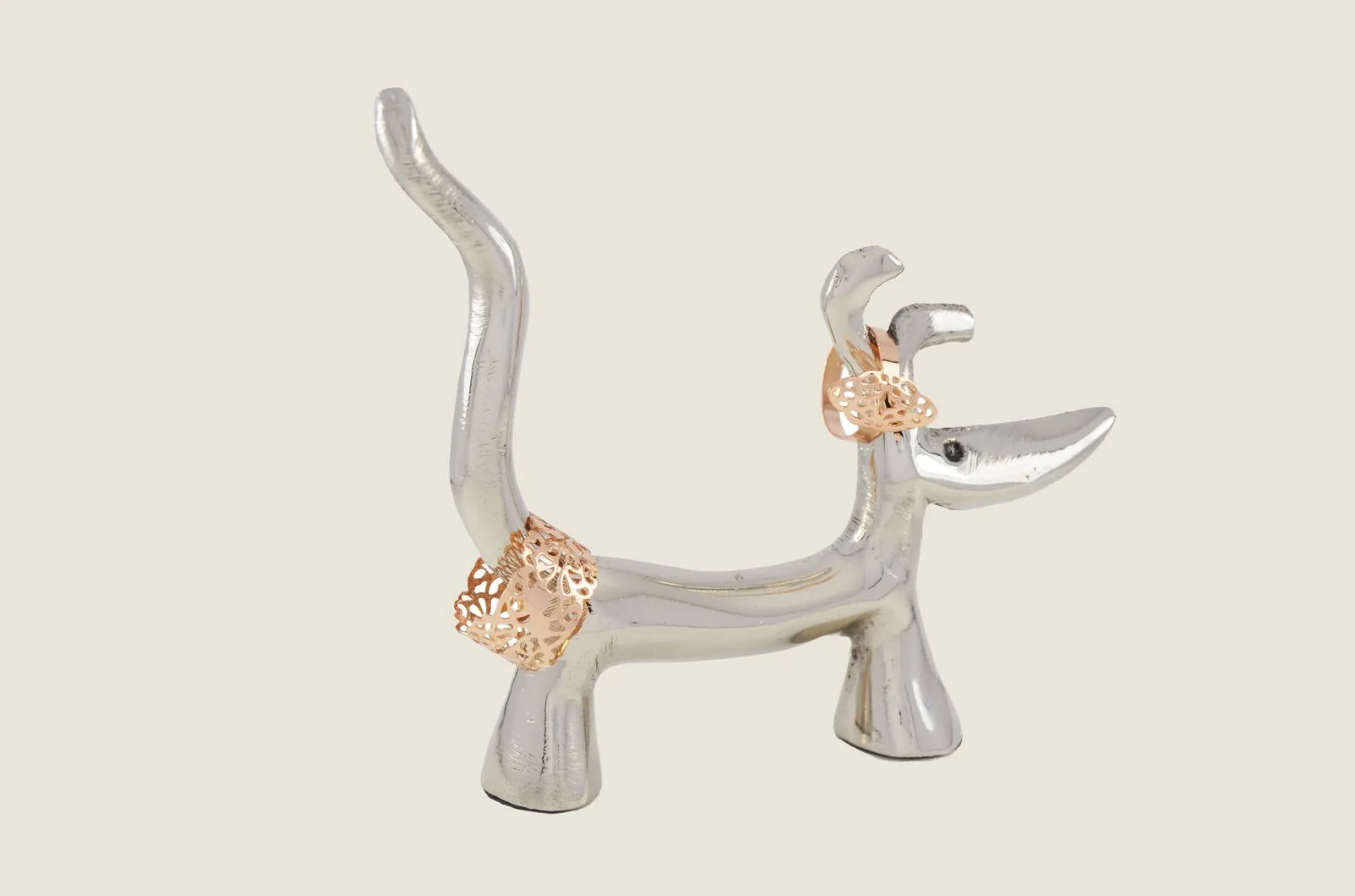 Handmade silver dog ring holder with decorative details, designed to stylishly display multiple rings.