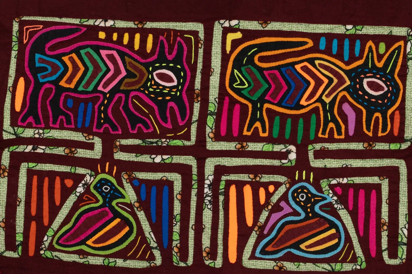 Hand-stitched Panama Mola featuring vibrant designs of a puppy and a bird, framed by colorful floral patterns.