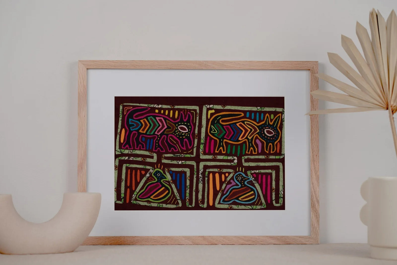 Colorful hand-stitched Mola featuring a vintage bird and puppy dog on a dark background, showcasing intricate patterns.