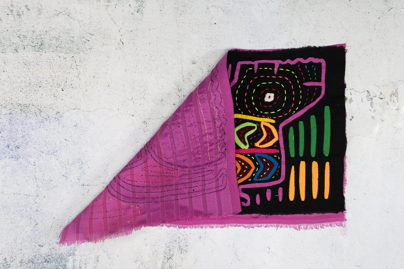 Hand-stitched vintage black and purple Mola tapestry featuring vibrant geometric patterns and designs.