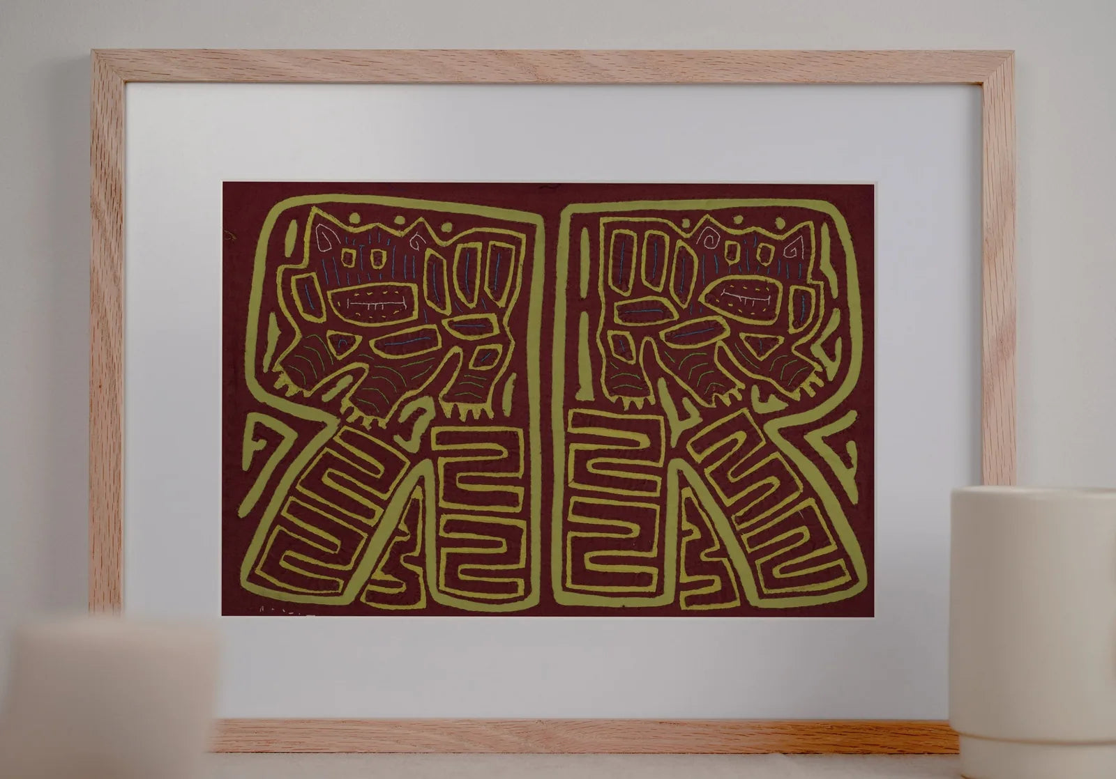 Hand-stitched vintage Mola in burgundy and green featuring playful dog designs and geometric patterns.