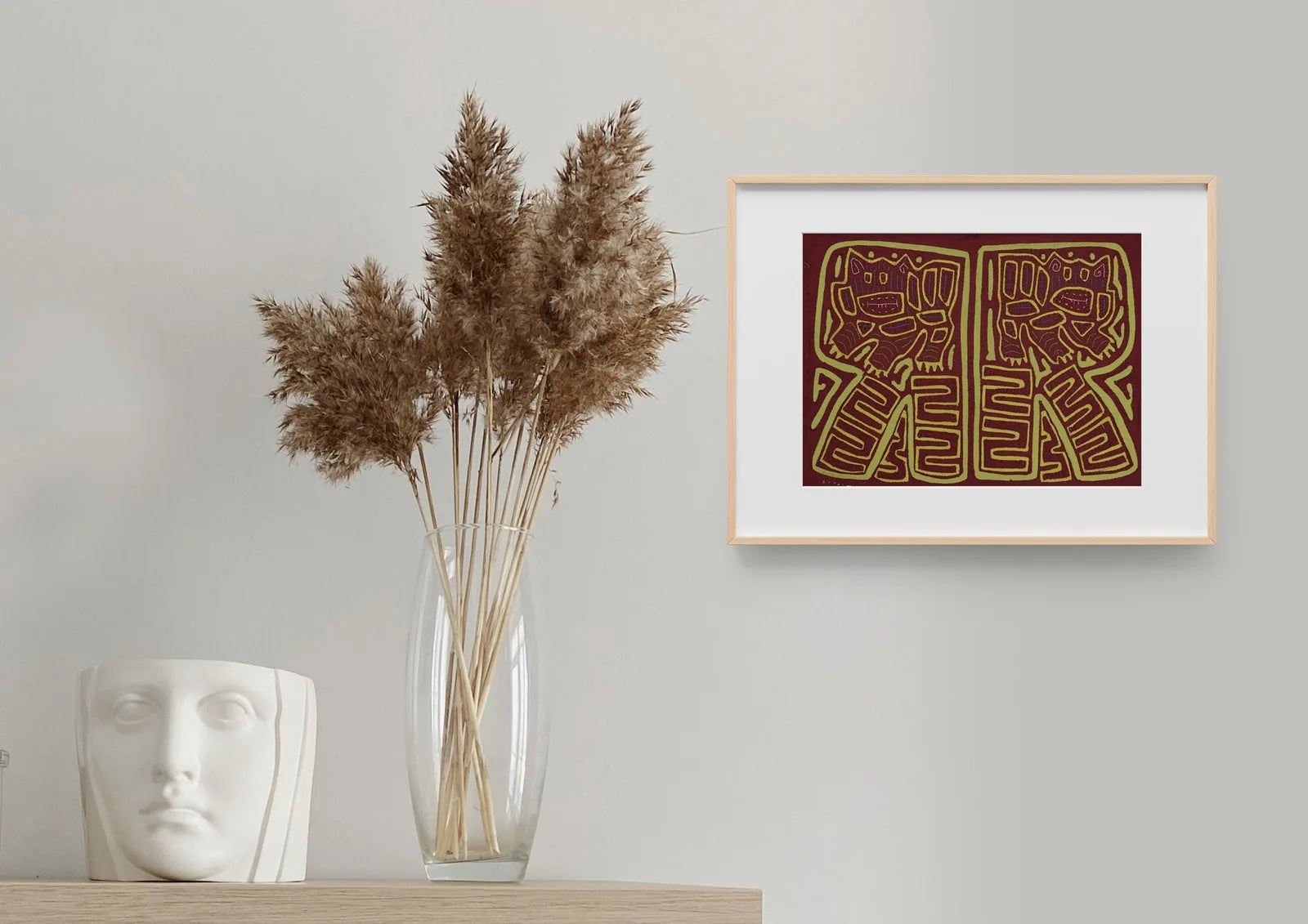 Hand-stitched vintage burgundy and green Mola featuring playful pups on a textured background, framed decoratively.