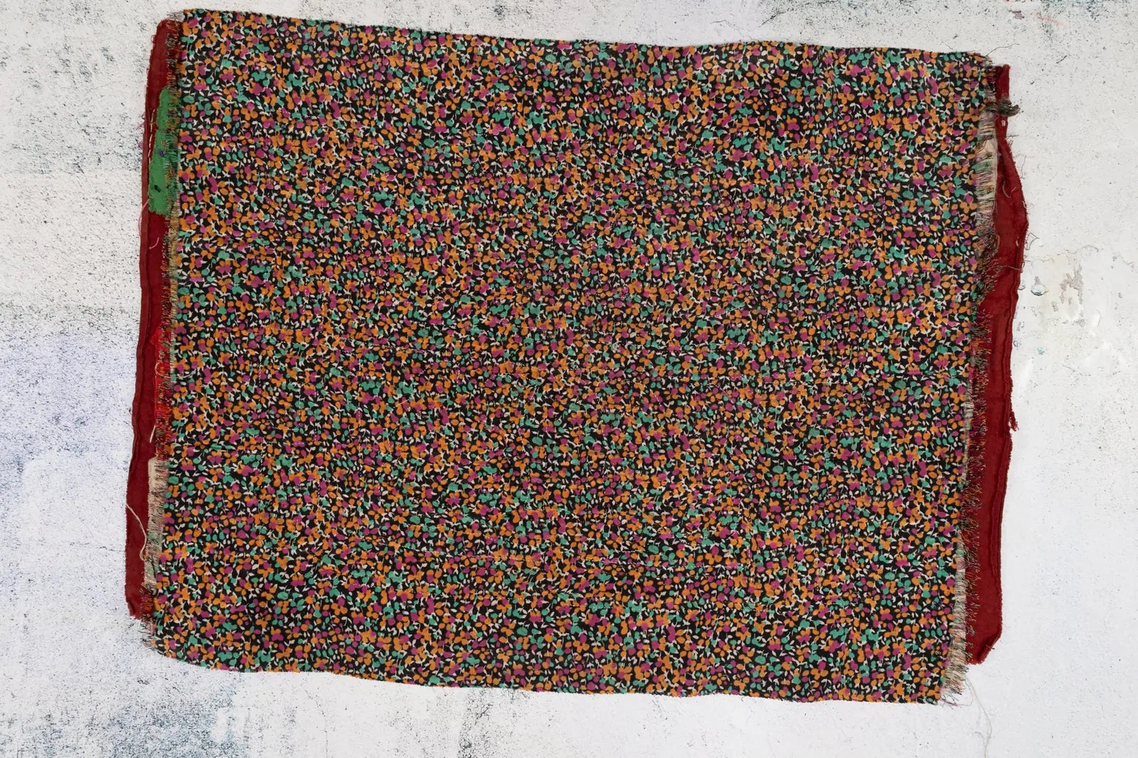 Hand-stitched vintage burgundy tapestry featuring a colorful patterned background, showcasing Guna artisan craftsmanship.