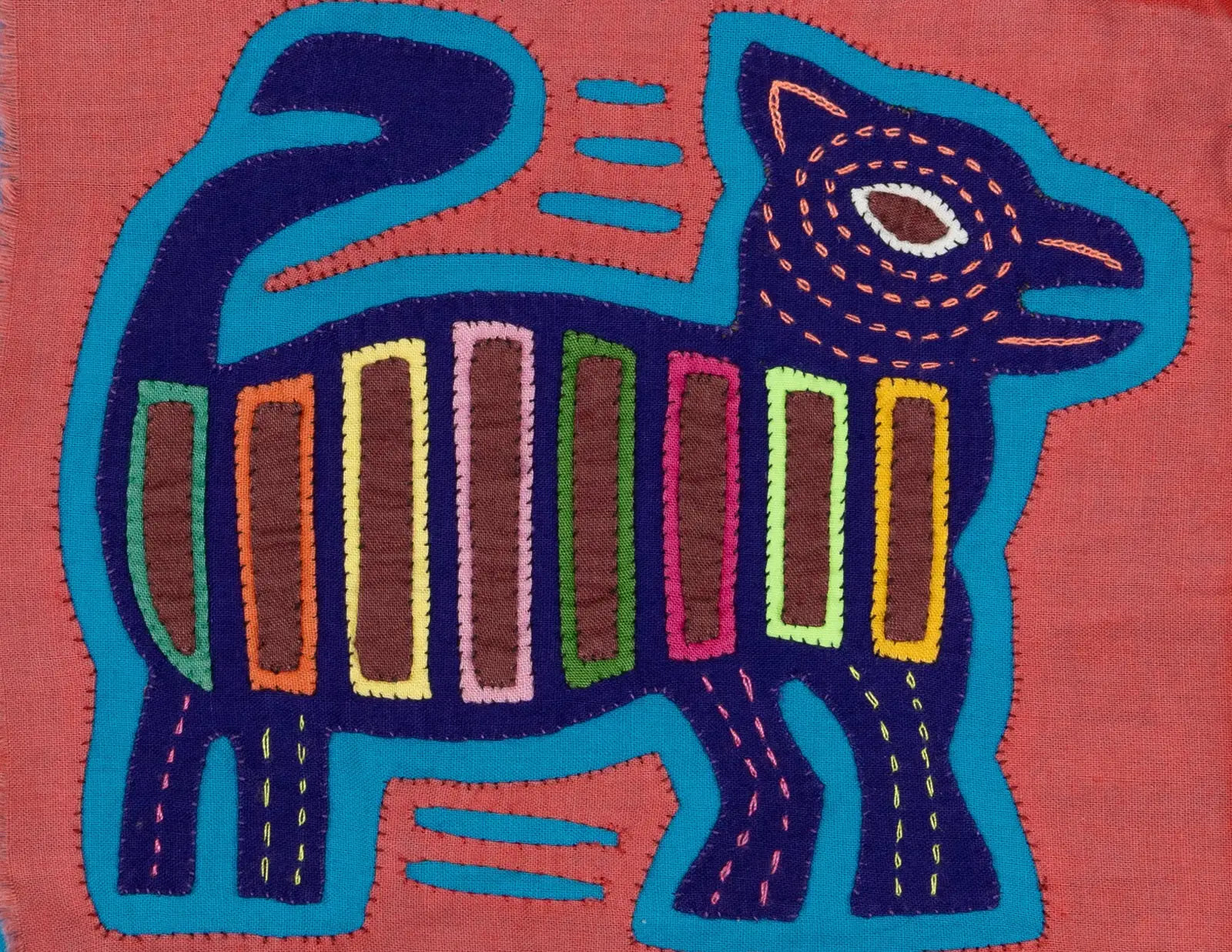 Hand-stitched vintage pink and purple Molita tapestry featuring a geometric puppy design on a coral background.