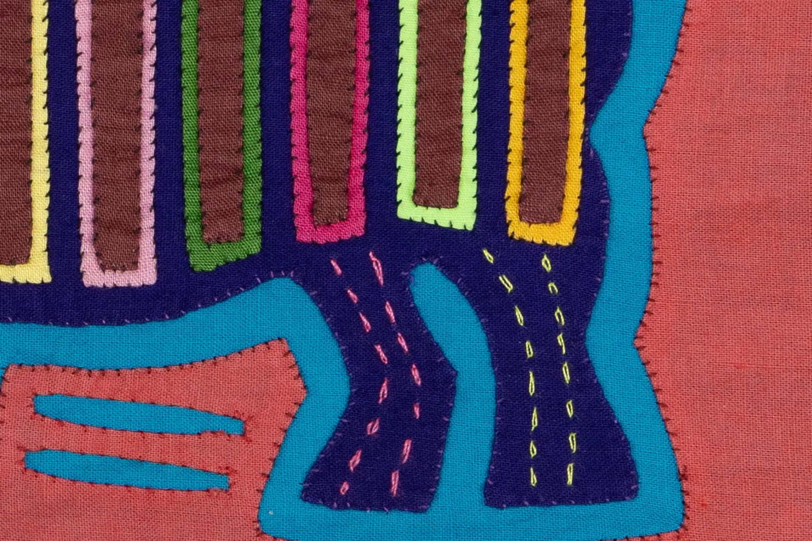Hand-stitched vintage pink and purple Molita design featuring geometric patterns on a colorful background.