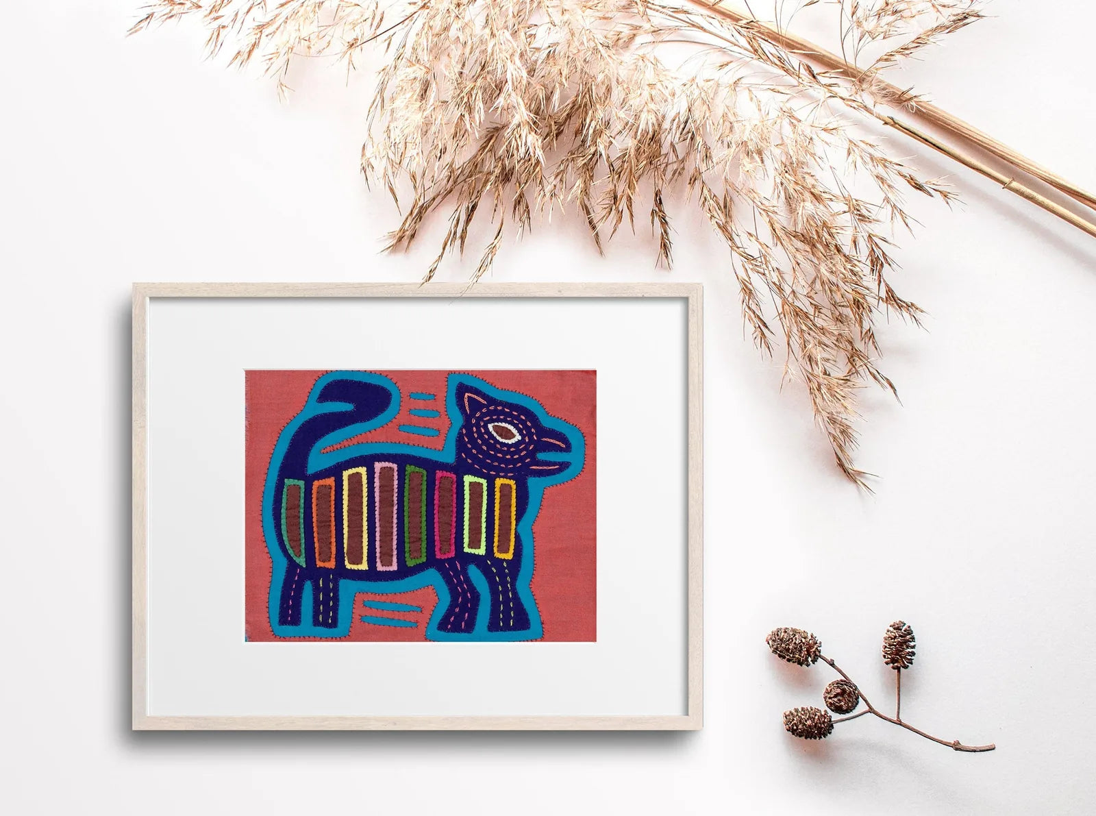 Vintage pink and purple Molita depicting a playful dog, featuring hand-stitched details and geometric patterns on soft fab...