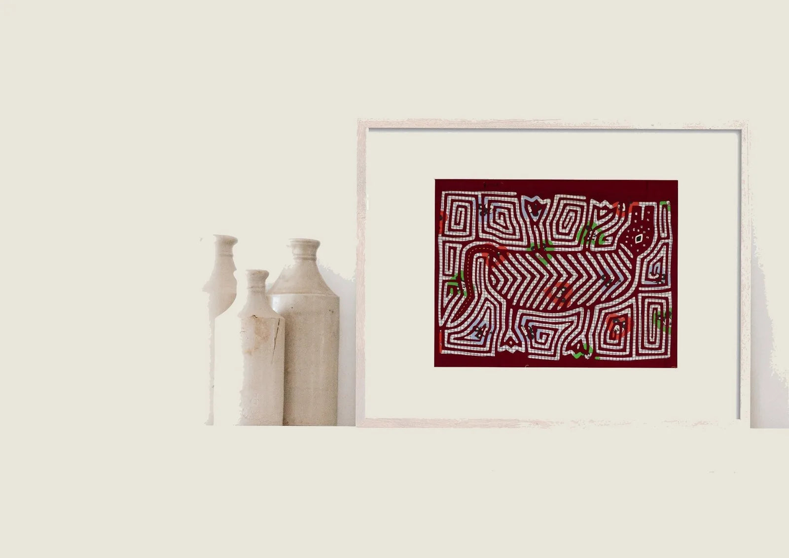 Hand-stitched red vintage puppy dog howling textile art in white and green patterns, framed and displayed with ceramic vases.