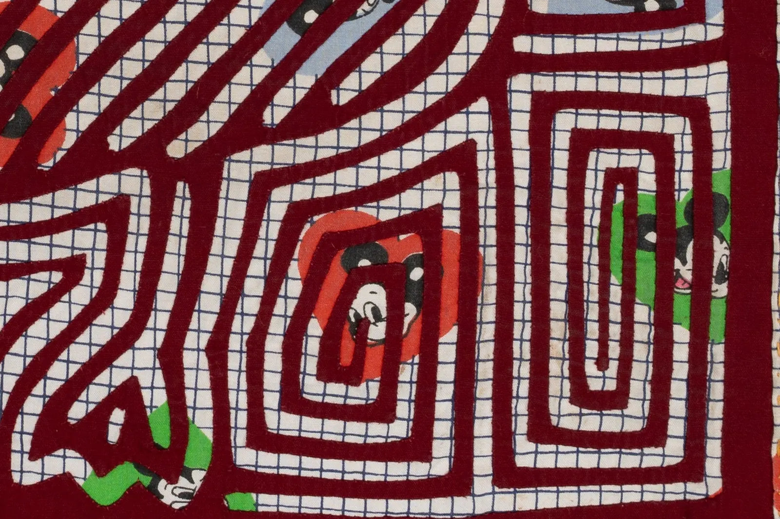 Vintage puppy dog howling motif on hand-stitched red, blue, and white Panama Mola tapestry, showcasing detailed textile art.