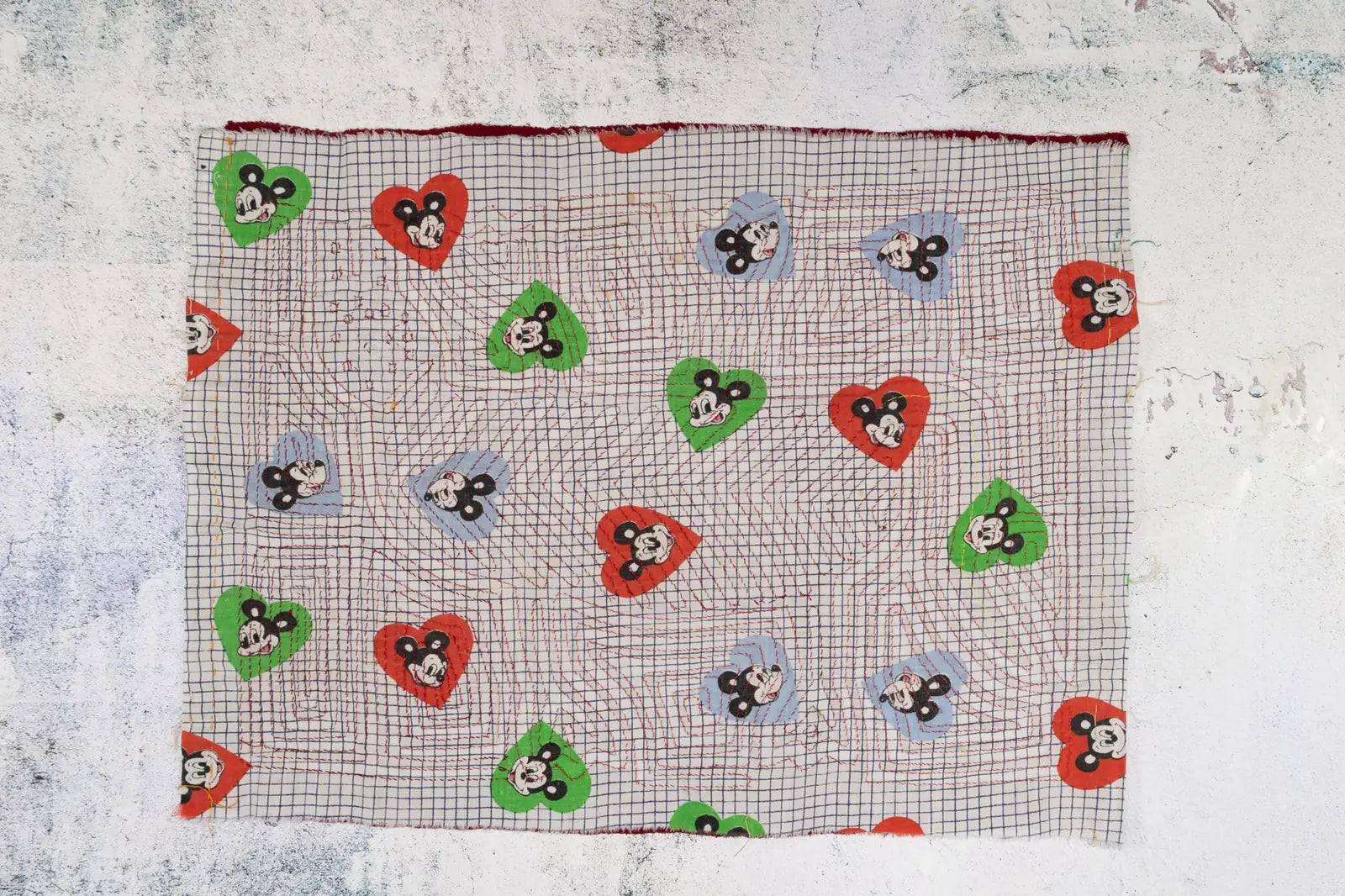 Colorful hand-stitched tapestry featuring a vintage puppy dog howling motif surrounded by heart shapes in vibrant colors.