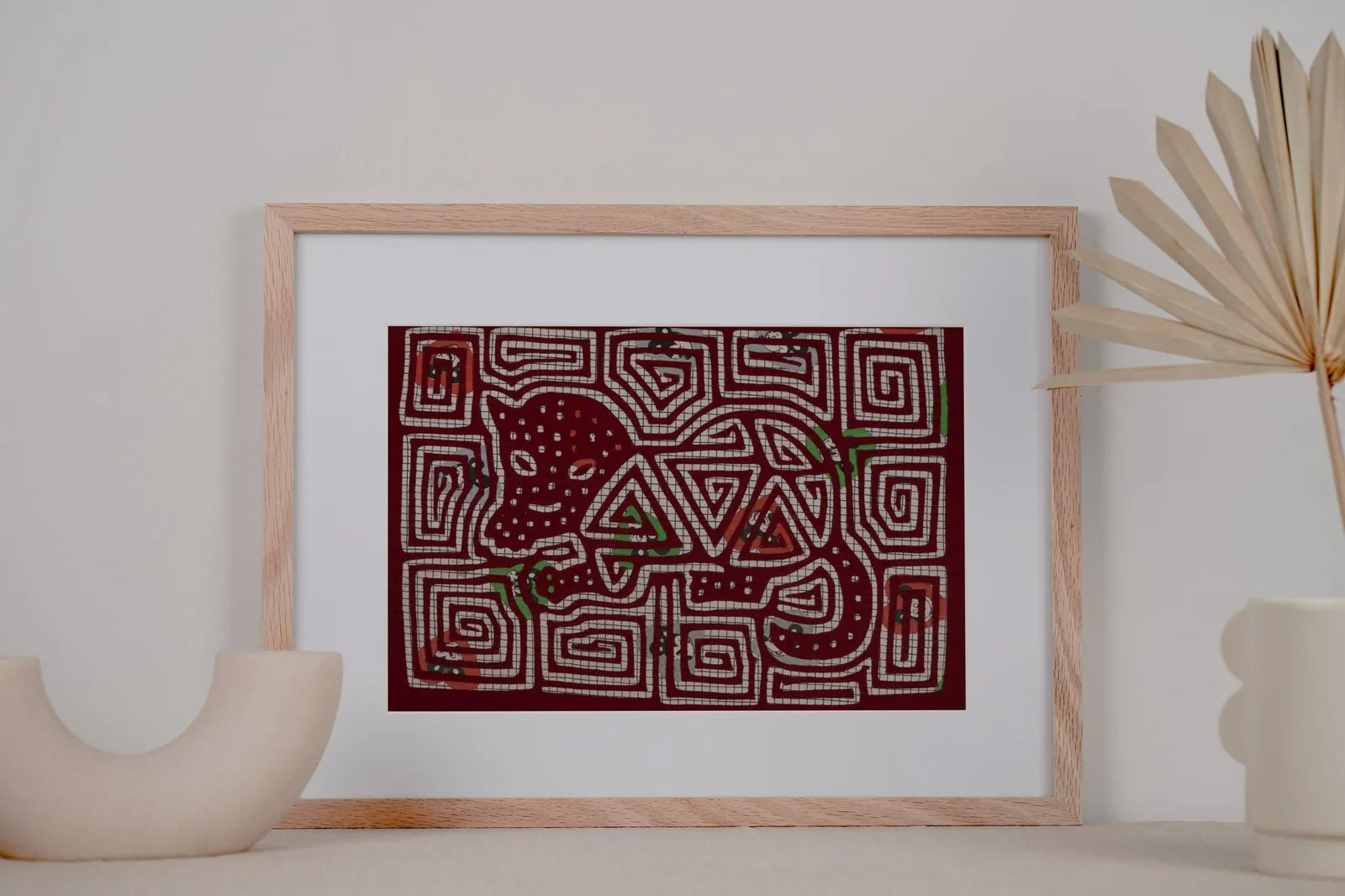 Hand-stitched vintage puppy dog mola tapestry in maroon with vibrant geometric patterns and natural motifs, framed for dis...