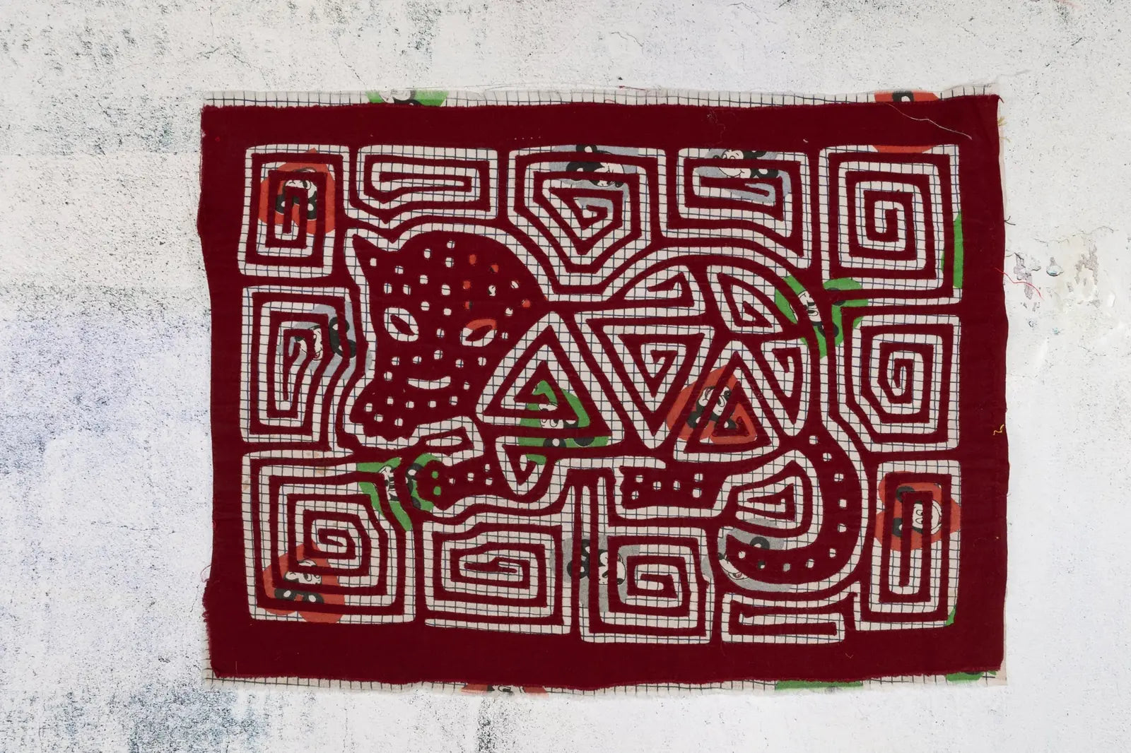 Hand-stitched vintage puppy dog tapestry in rich burgundy with intricate white and colorful patterns, showcasing Guna arti...