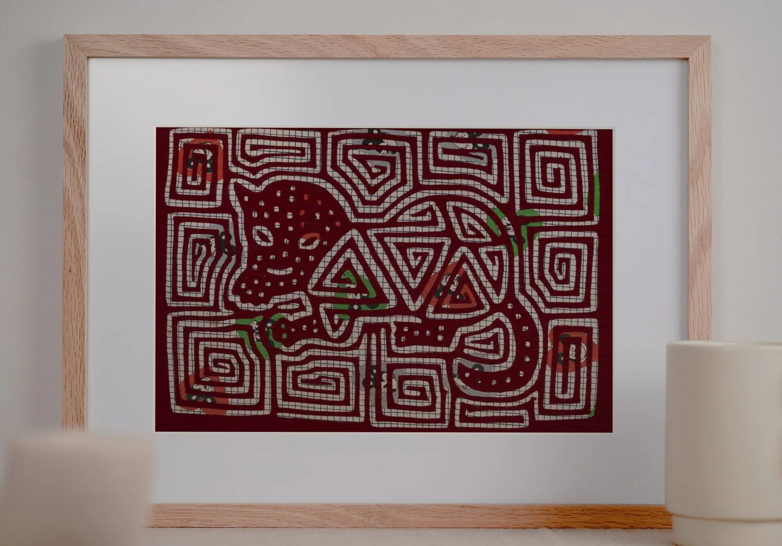 Colorful vintage puppy dog tapestry with intricate white patterns on a deep red background, framed and displayed decorativ...