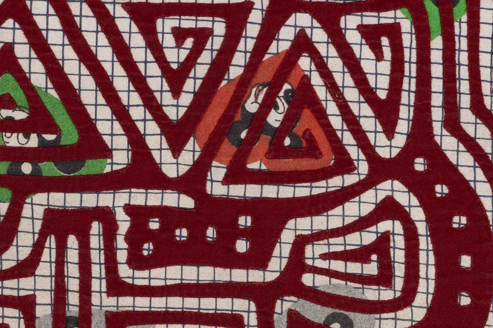 Colorful abstract patterns in red, green, and black on cream background; a unique hand-stitched vintage puppy dog tapestry.