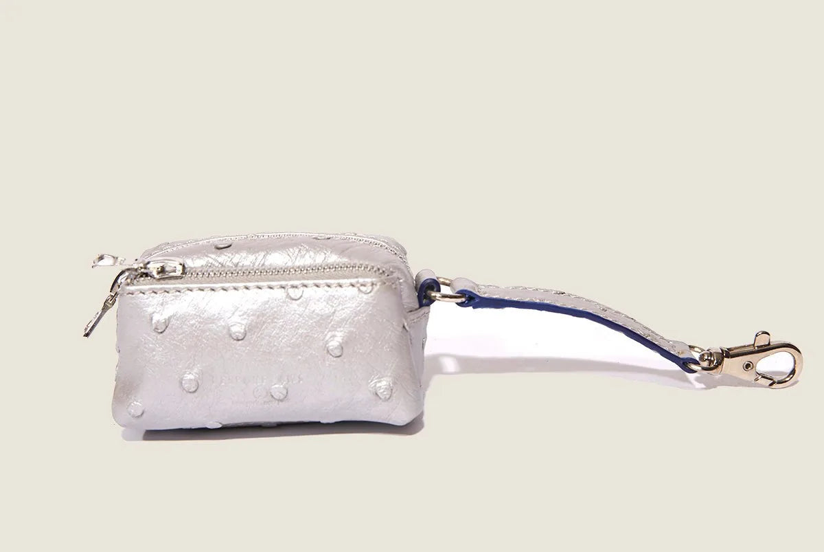 Silver ostrich-patterned waste bag dispenser with a clip, featuring a zip closure and lightweight design.