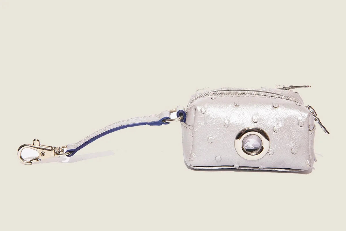 Silver ostrich-patterned waste bag dispenser with a clip, zipper closure, and accent ring for easy access.