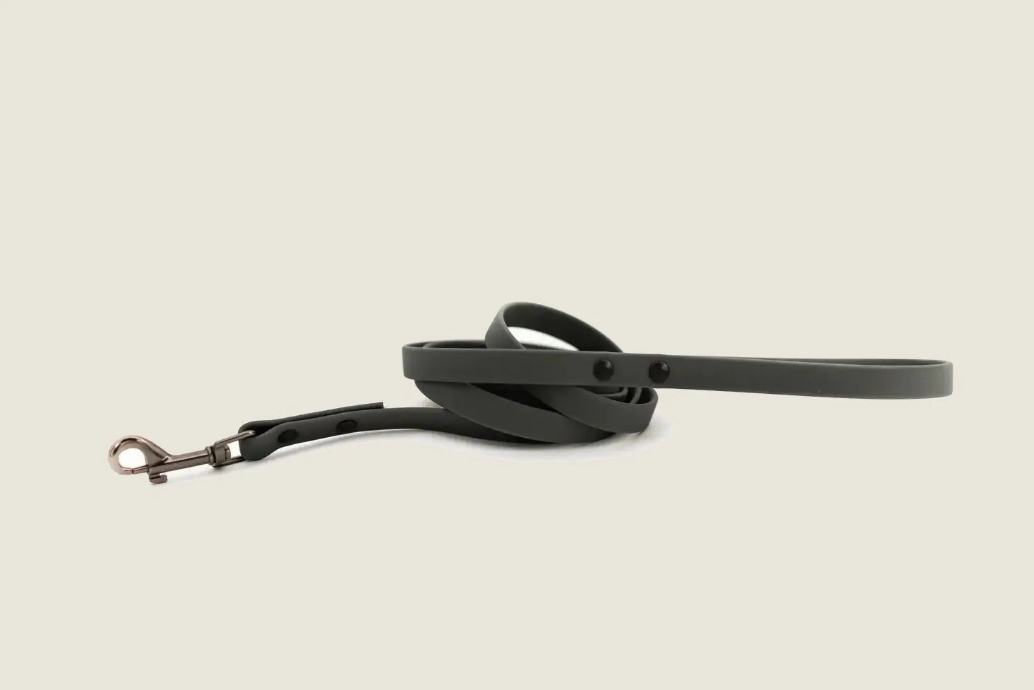Waterproof charcoal dog leash made of soft PVC, coiled with a durable design and a sturdy clip for control.