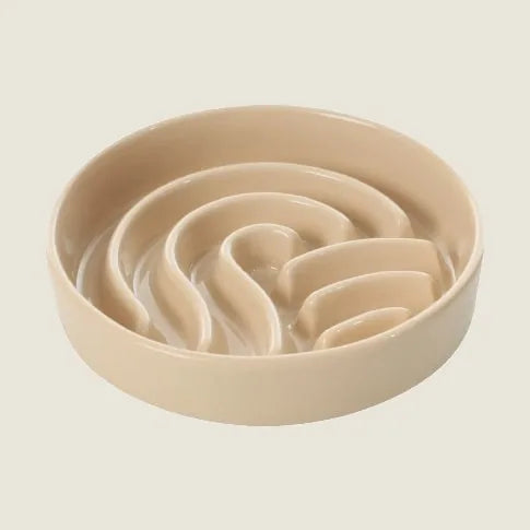 Beige slow feeder dog bowl with a wave pattern, made from food-grade ceramic for easy cleaning.