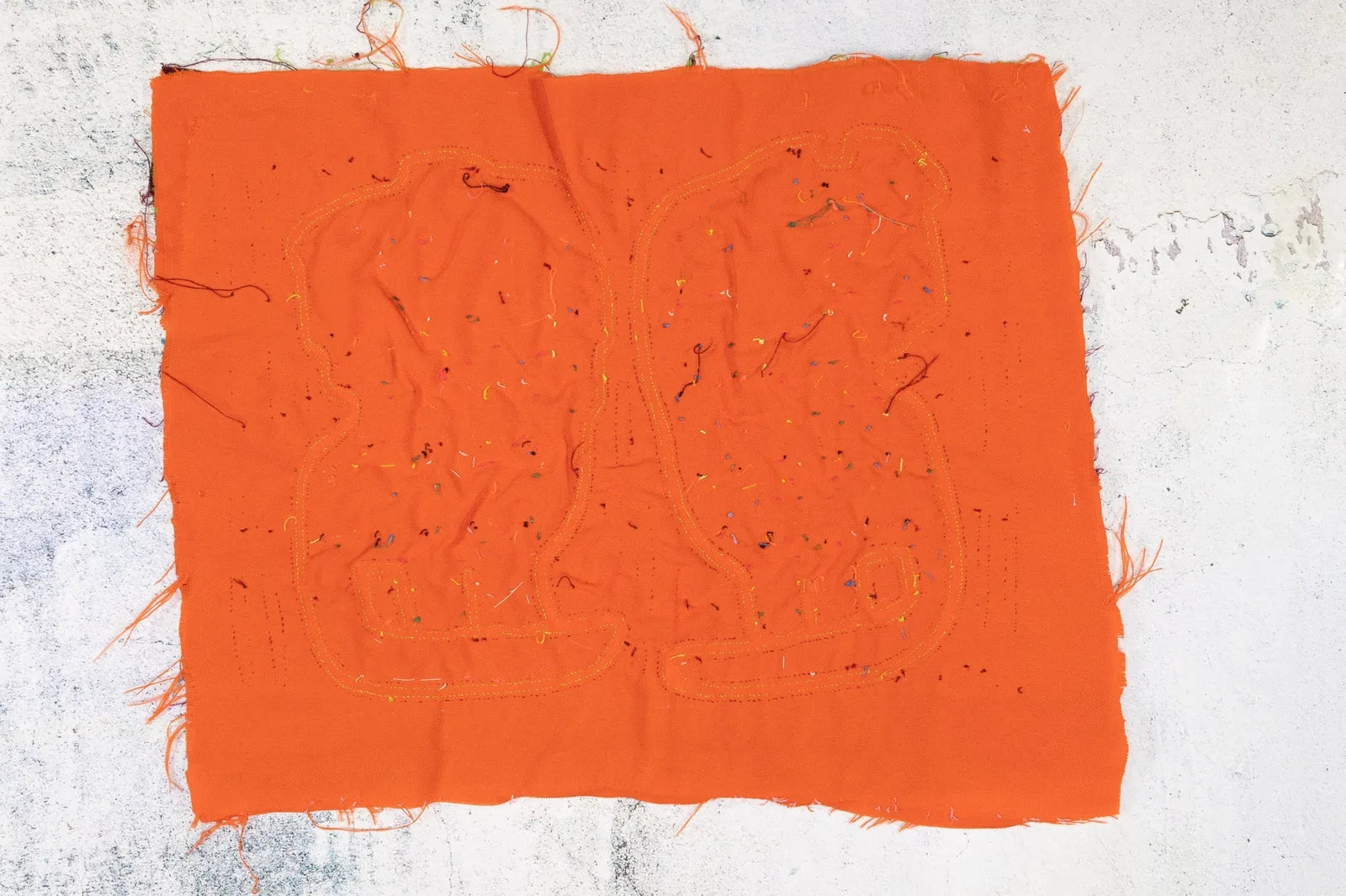 Hand-stitched bright orange tapestry featuring playful designs with colorful thread accents, showcasing unique Panamanian...