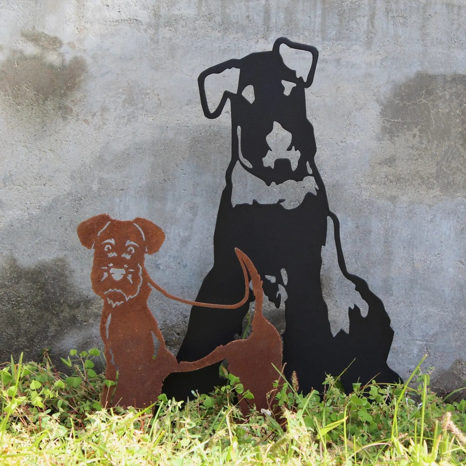 Welsh Terrier metal silhouette in Corten steel and black, set against a textured concrete background, perfect for outdoor...