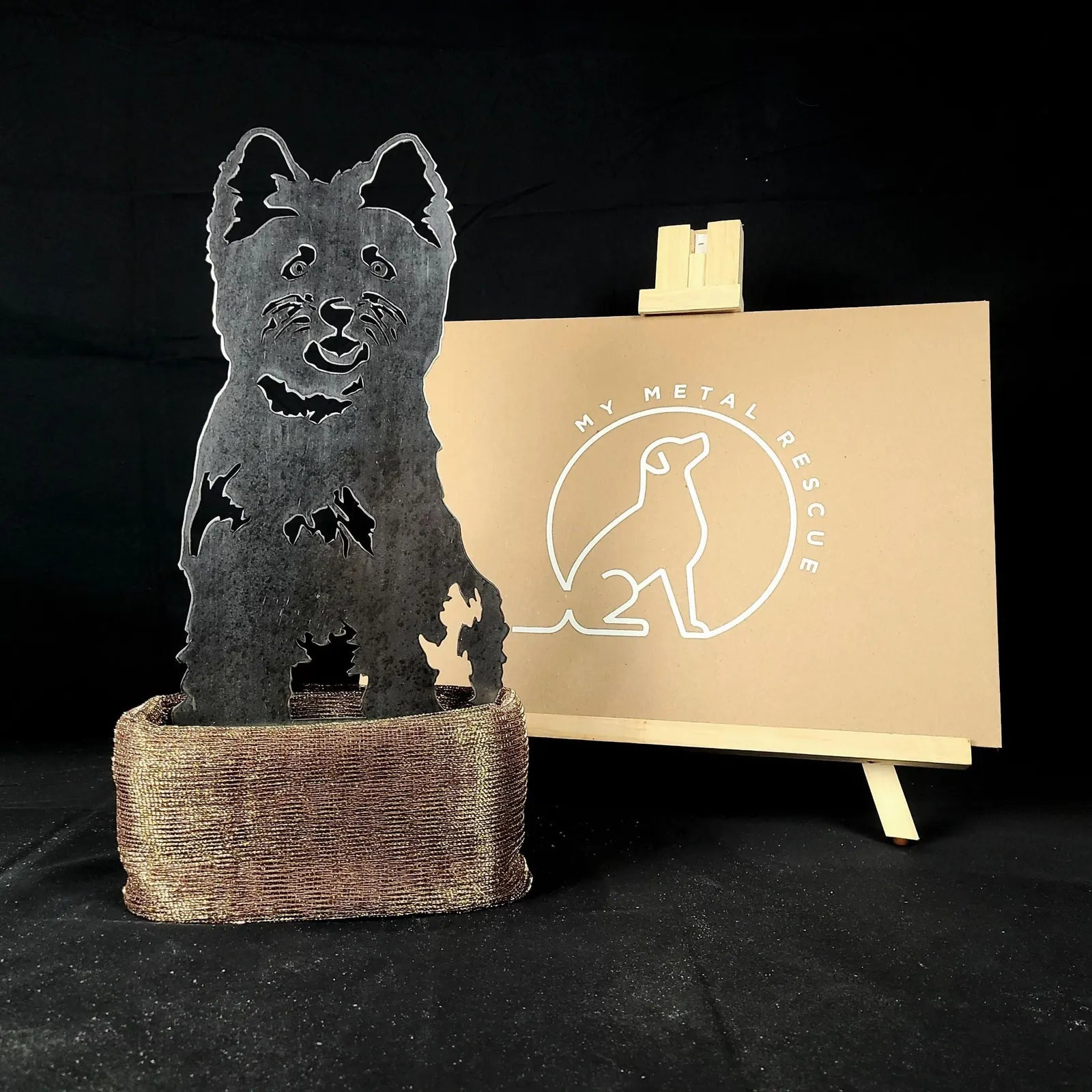 West Highland White Terrier silhouette in weathered metal, displayed in a rustic holder, accentuating outdoor decor.