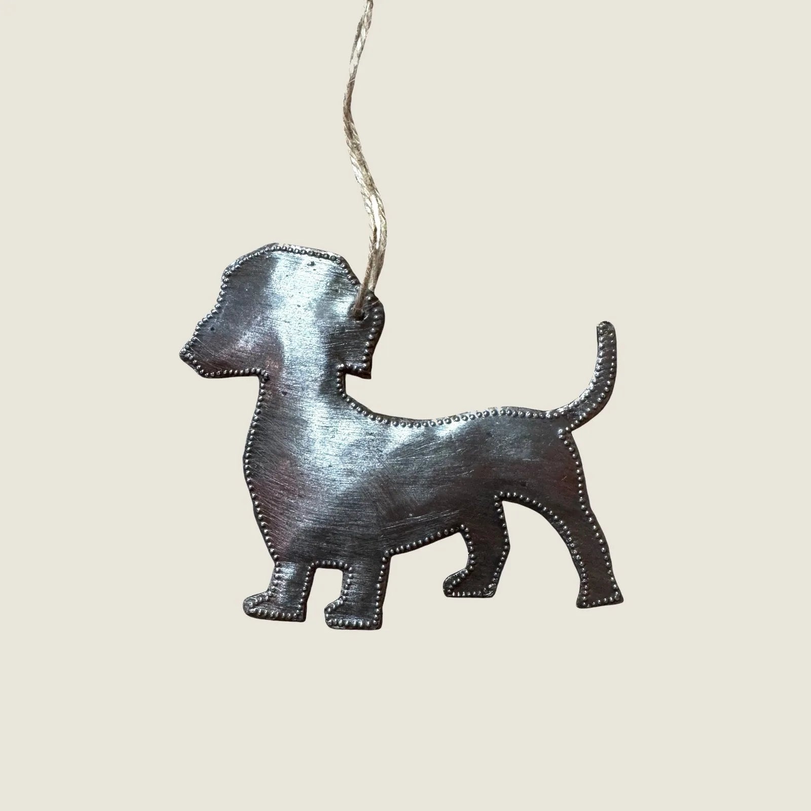 Handcrafted silver Wiener Dog ornament made from recycled steel, featuring a unique design and hanging twine.