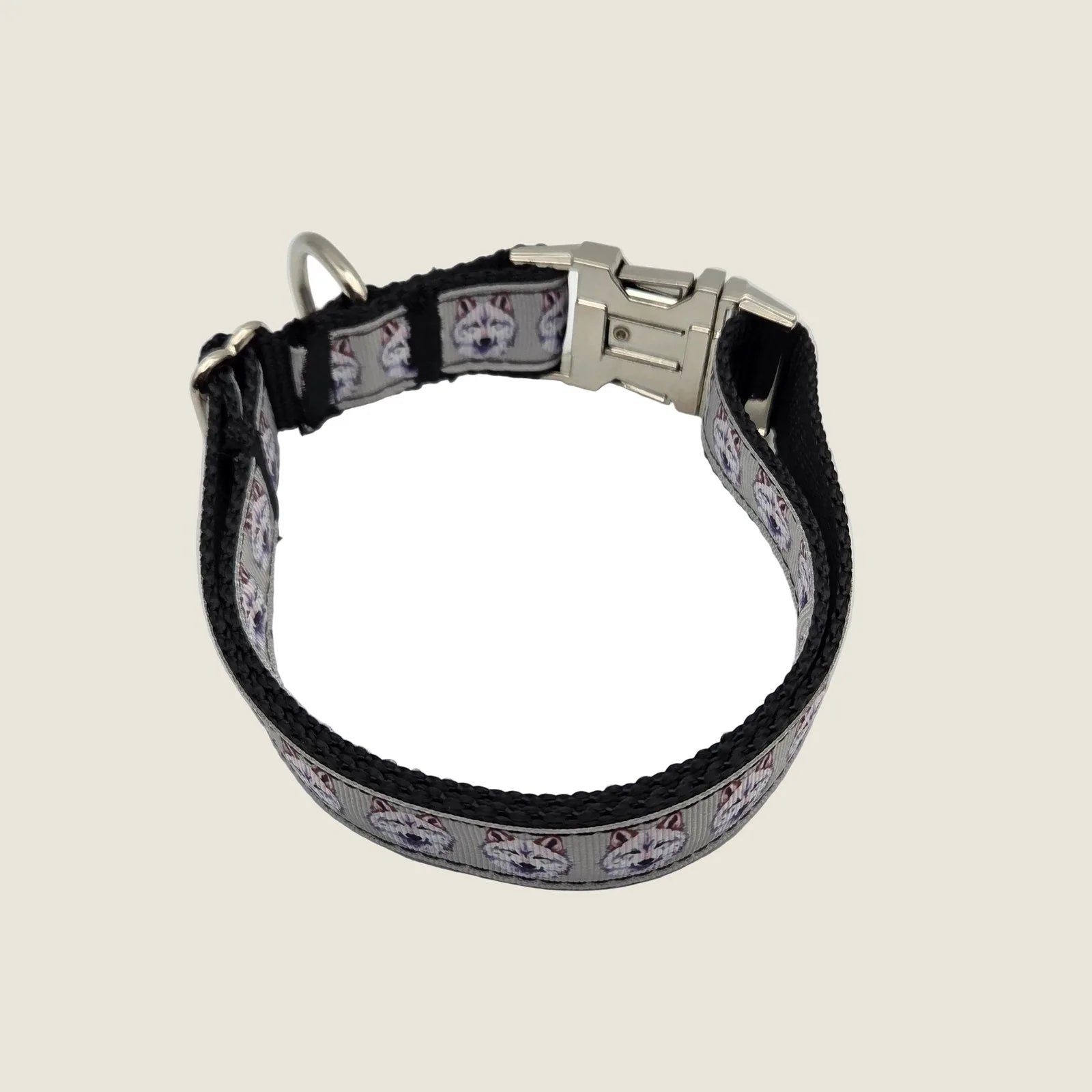 Adjustable gray and white wolf-printed dog collar, featuring durable black nylon and a polished metal buckle.