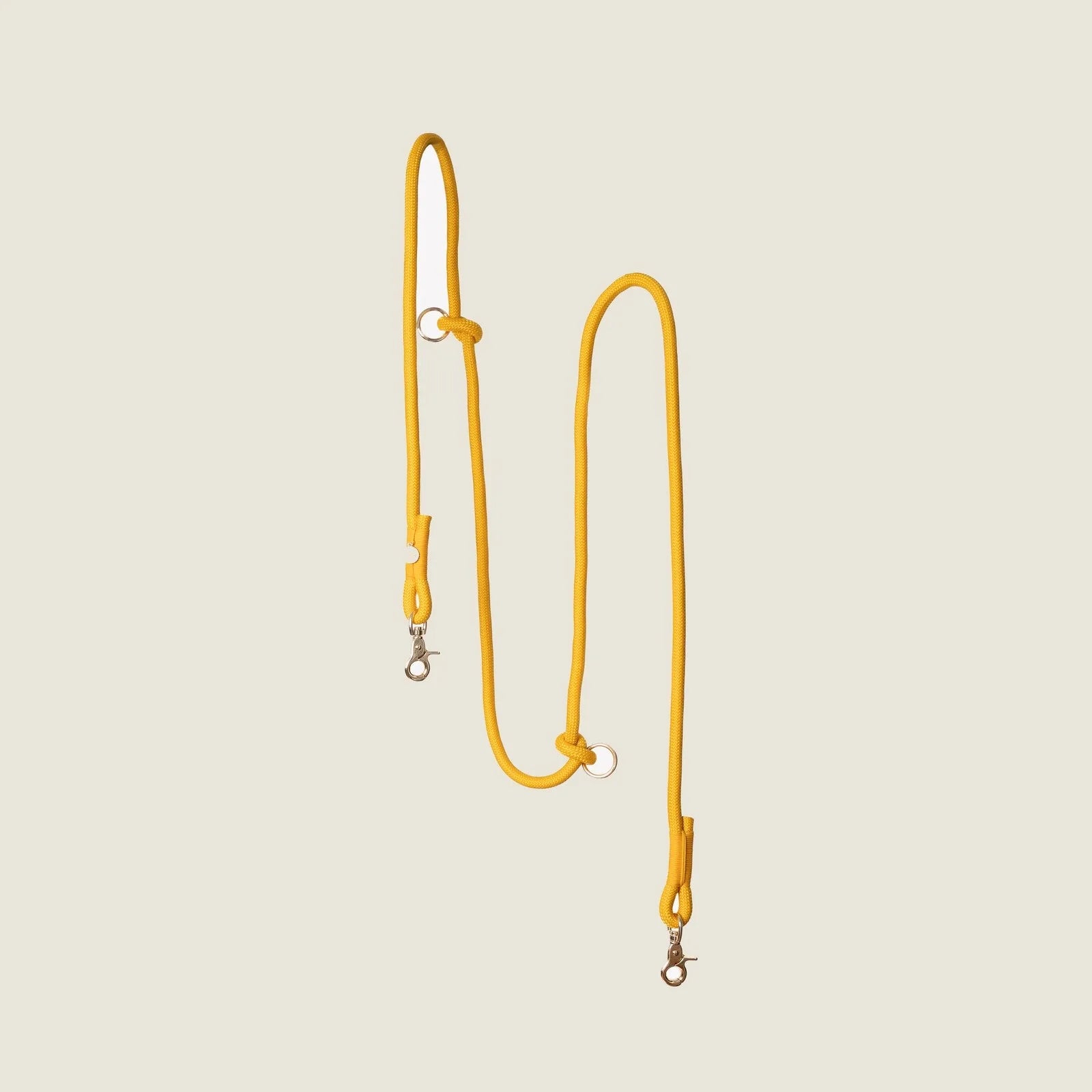 Yellow hands-free braided leash with multiple clips and loops, perfect for walking dogs while keeping hands free.
