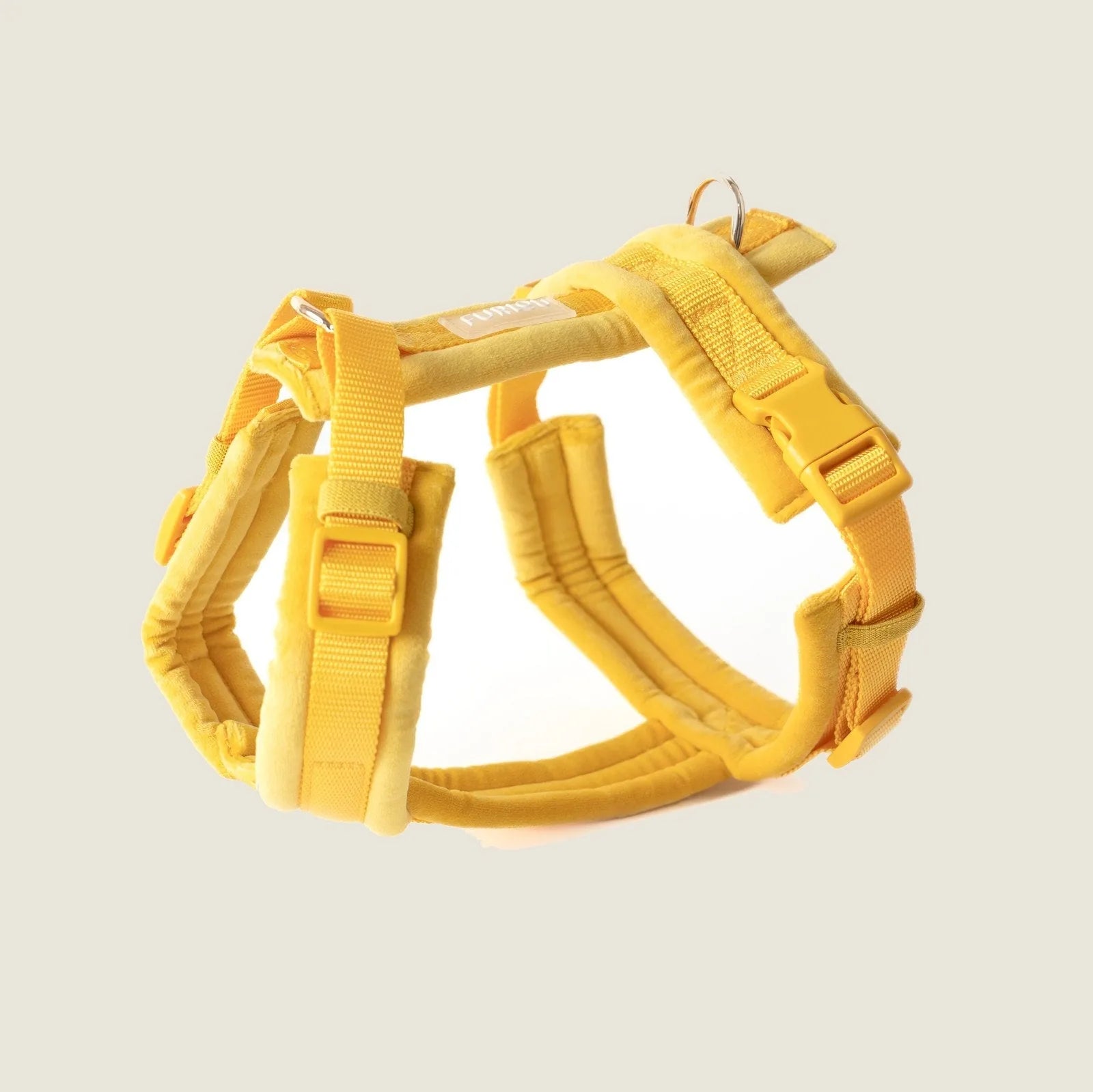 Yellow velvet dog harness featuring adjustable straps and gold hardware for comfort and style.