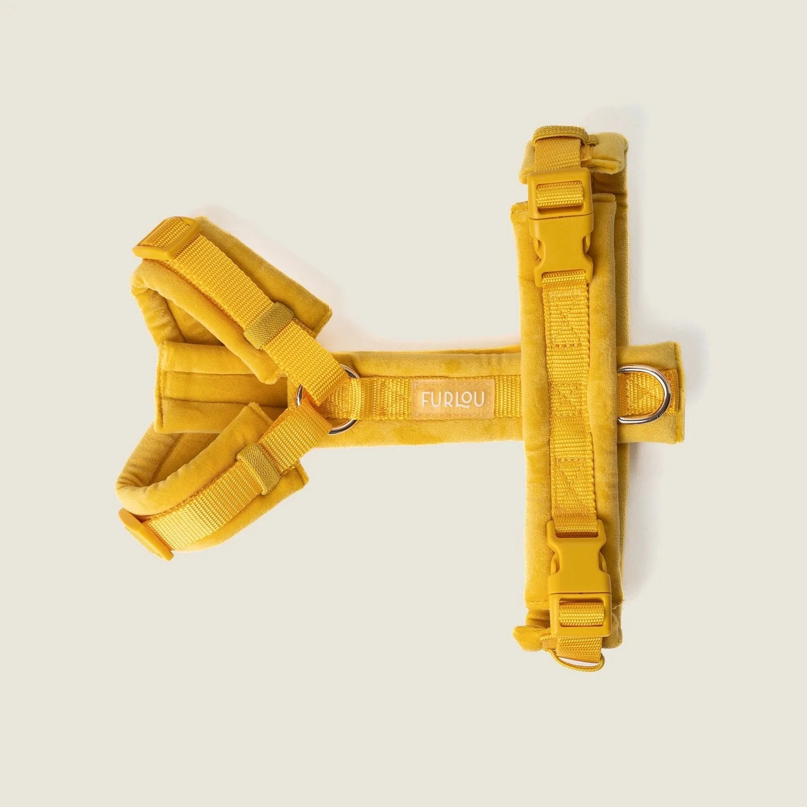 Yellow velvet dog harness by FURLOU features plush fabric, adjustable straps, and gold hardware for stylish comfort.