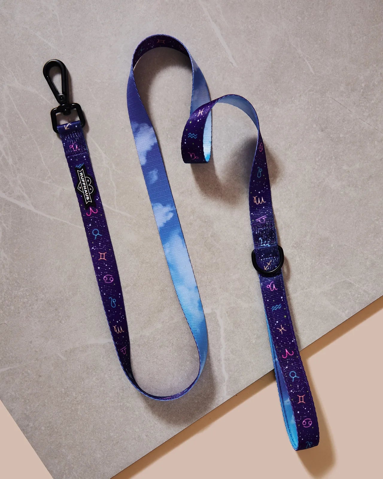 Zodiac Drip Dog Leash in purple with astrology designs, featuring a soft handle and swivel snap clasp on a light background.